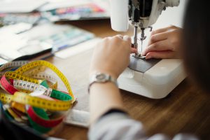 Japanese fashion designer working in studio.
